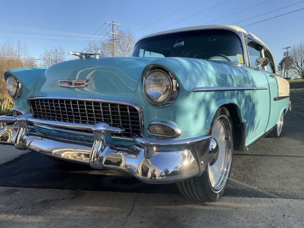 Front three-quarter view of Foss’ turquoise 1955 Chevrolet Bel Air showing chrome grille, bumper and wheels